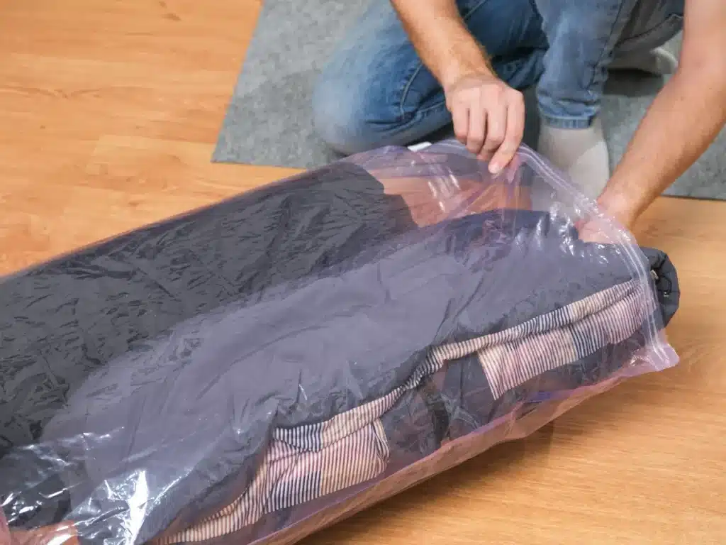 Pack clothes in garbage bags.